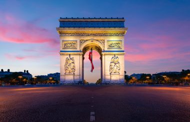 Arc de Triomphe de Paris at night in Paris, France.